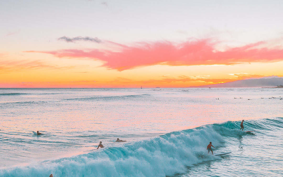 Image of sunset with surfers